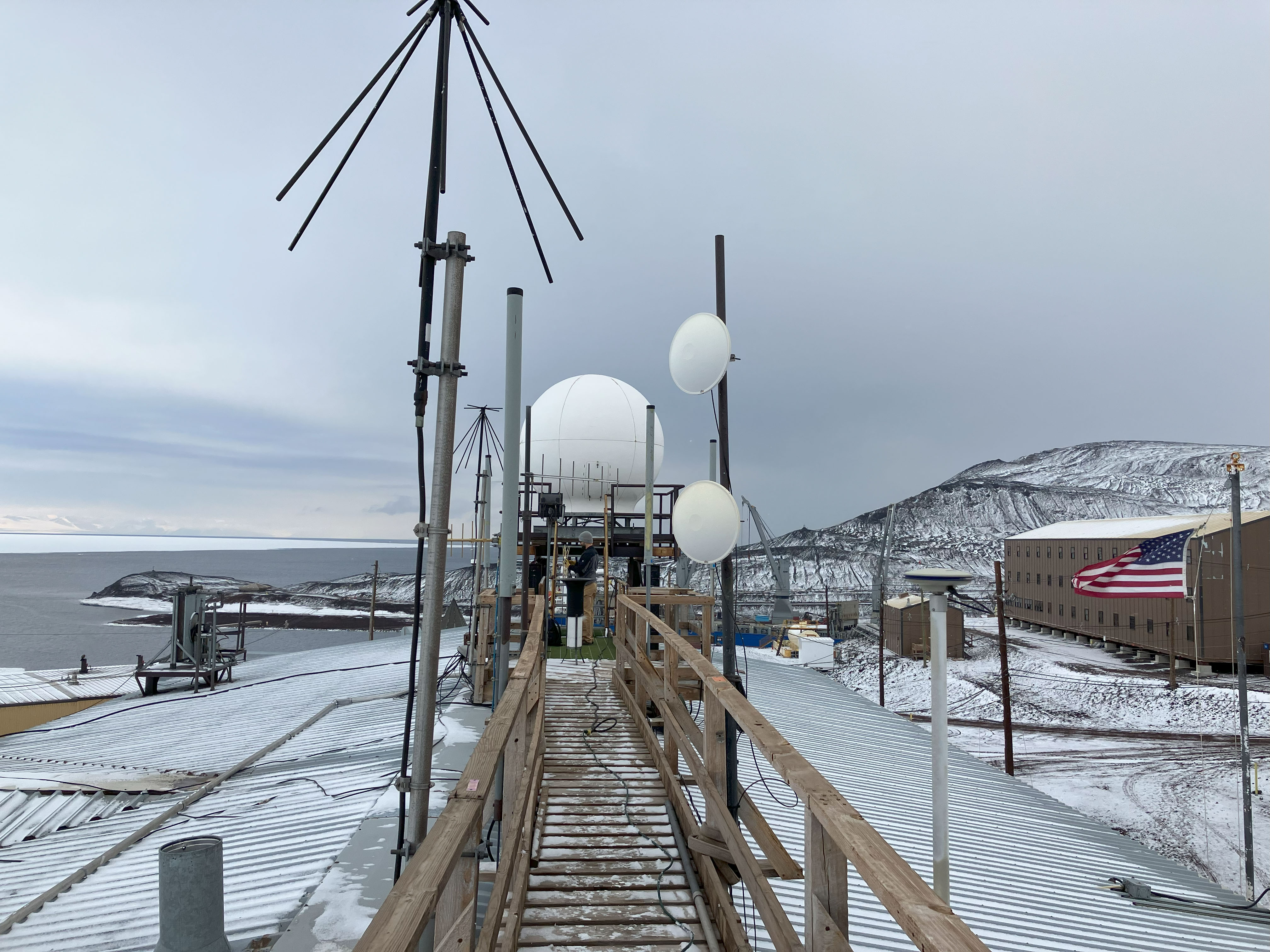 A variety of RF antennas against an Antarctic landscape.